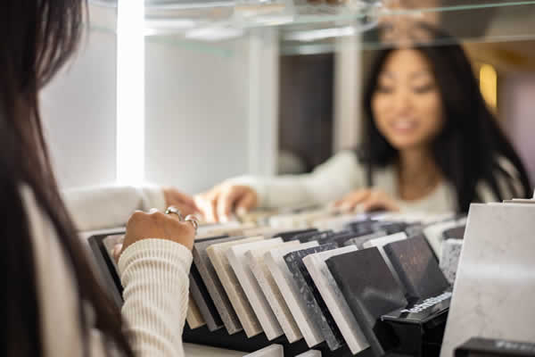 2 women looking at samples of quartz material